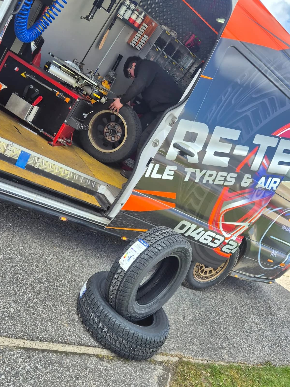 Tyre-Tec technician fitting a tyre inside the mobile workshop van